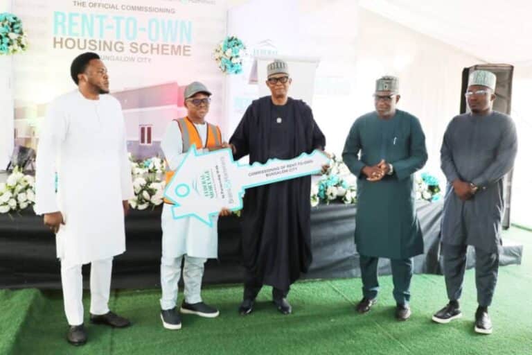 Officials present the symbolic key to a beneficiary during the commissioning of the Renewed Hope Rent-to-Own Housing Scheme at Bungalow City, Abuja.
