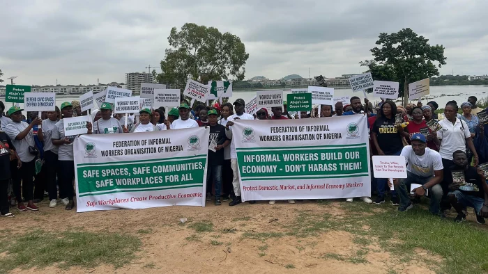 Protesters gather at Jabi Lake Recreational Park in Abuja, holding banners and placards demanding transparency, environmental protection, and the release of the FCTA redevelopment agreement.