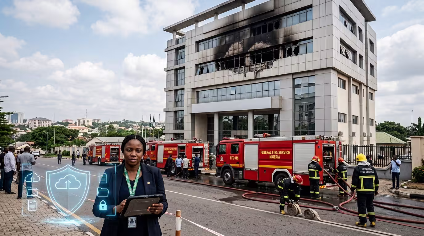 Firefighters outside the Federal Mortgage Bank of Nigeria headquarters in Abuja after a fire, illustrating that NHF records and mortgage data remain secure.